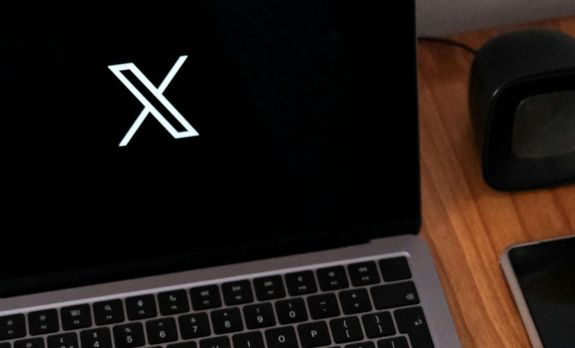 X logo on laptop 825x500 1